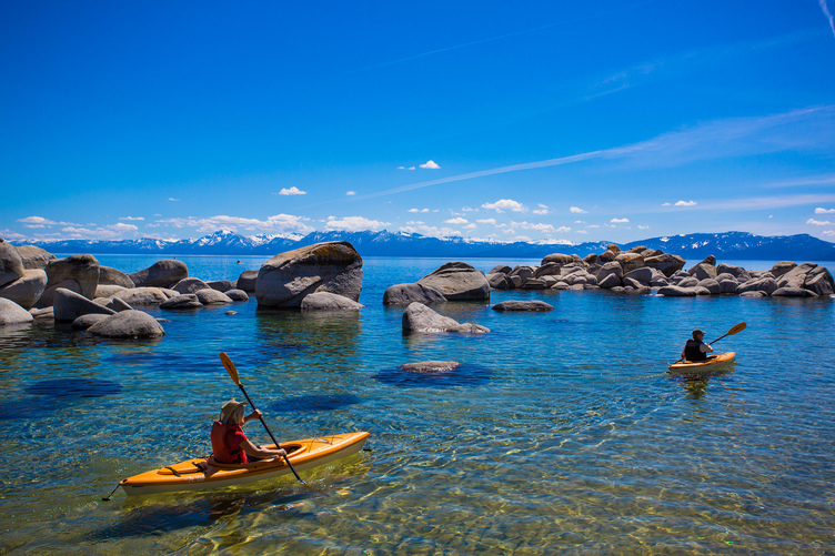 2 people on a kayak at a Lake Tahoe beach
