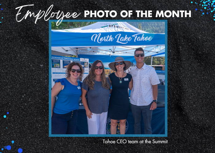 Employee photo of the month by Steven Wilson of four Tahoe CEO employees smiling in front of the county booth at the Summit.