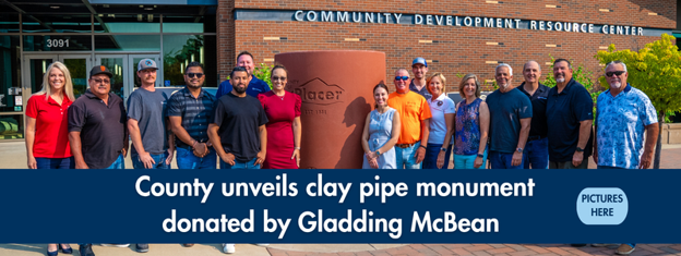 Group of representatives from Placer County, City of Lincoln and Gladding McBean pose for a group picture around the new clay pipe monument