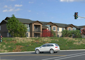 A rendering of the Hope Way apartments with a car in the street