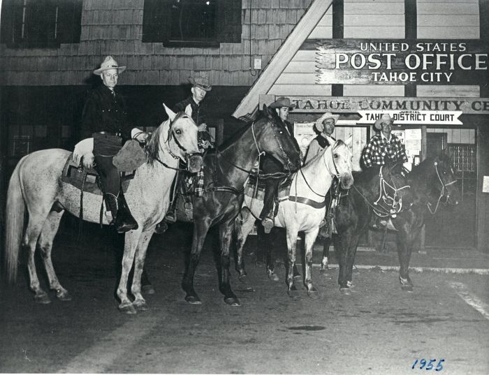 Five riders on horses posed in front of the Tahoe City post office