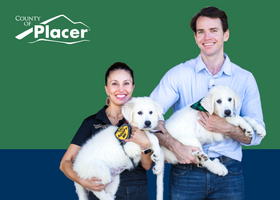Supervisor Shanti Landon and Congressman Kevin Kiley pose together each holding a white puppy with Placer County logo in the corner