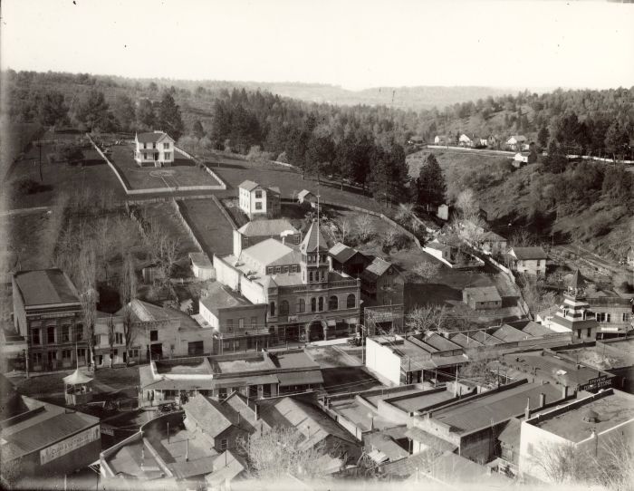 Historic photograph of the small Gold Rush-era town of Auburn, tucked into a cleft between hills
