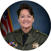 Profile image of Captain Michelle Baxter from the Placer County Sheriff's Office in a green uniform with a badge. 