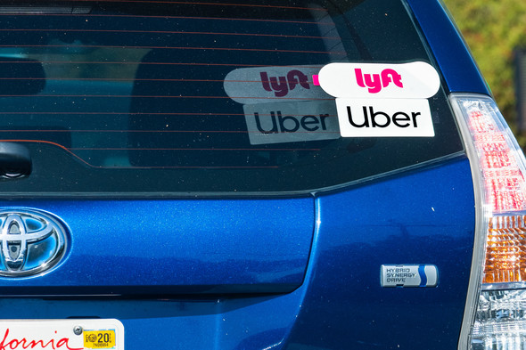 vehicle with Uber & Lyft stickers on rear window