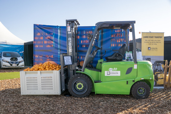 zero-emission forklift with a container of oranges at the World Ag Expo