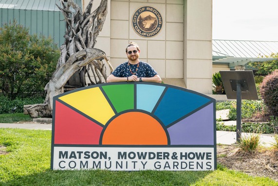 Phillip Moller with Matson, Mowder, and Howe Community Garden Sign