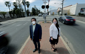 Councilmembers Edwards and Melendrez standing on Third Street near the train tracks.