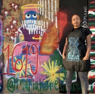 Mariah Green stands in front of her mural at Urge Palette, c. protests of June 2020