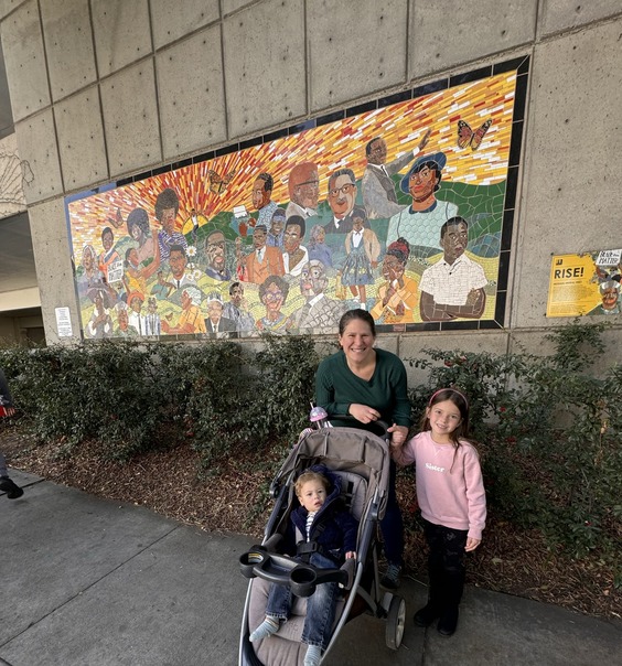 Councilmember Edwards and family stand in front of RISE Mural in Downtown