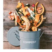 Fruit and vegetable scraps fall into a bucket that says, "compost."
