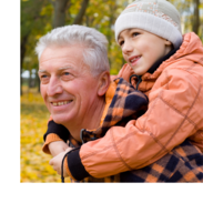 A little girl gets a piggyback ride from her grandfather.