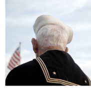 An older man wearing a sailor's uniform.
