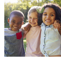Three small children smiling