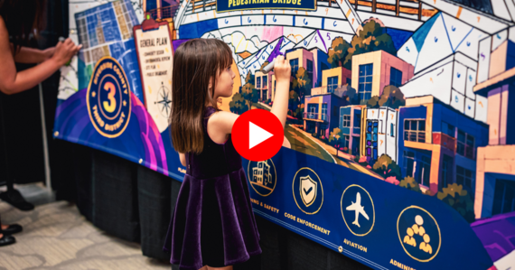 Young girl painting a community mural at the State of the Third District