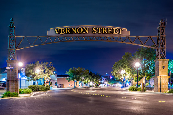 Photo of the Vernon Street archway at night time, welcoming you into a brightly-lit Downtown Roseville