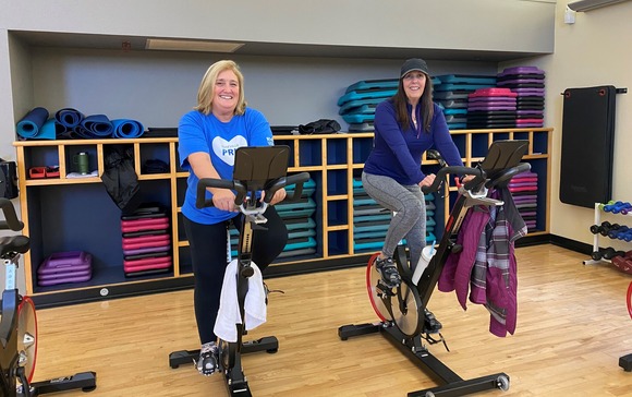 Photo of two women using cycling machines at the Mahany Fitness Center