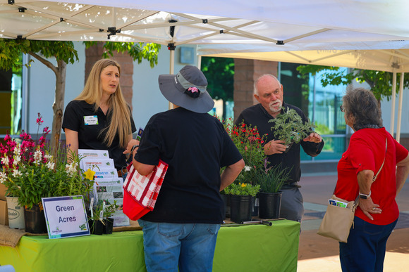 Photo of two gardening experts chatting with Garden Gab participants under a pop-up tent.
