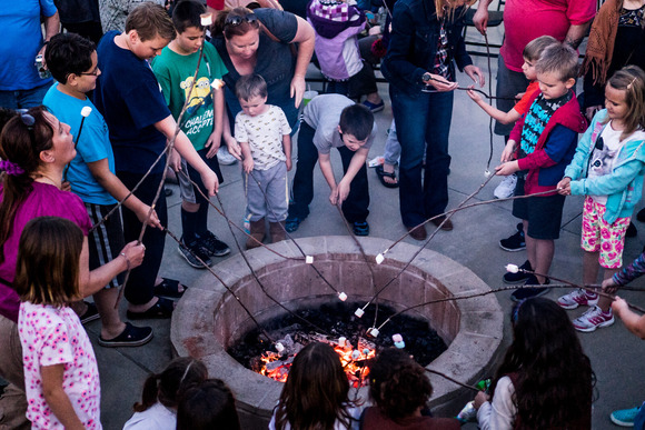Children roasting marshmallows around the campfire