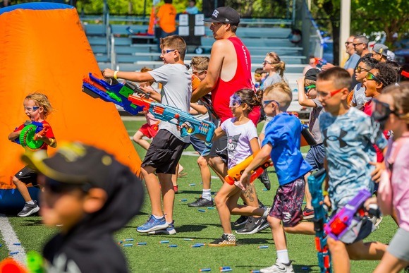 A group of kids holding up their blasters during Blaster Blitz