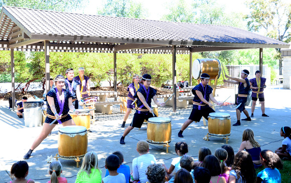A group of Taiko drummers performing on stage