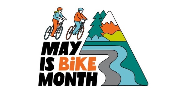 Cartoon illustration of two bicyclists next to a mountain, alpine trees, and river. Text reads, "May is Bike Month"