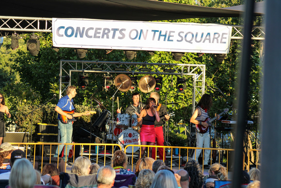 A band performs on stage during Concerts in the Square