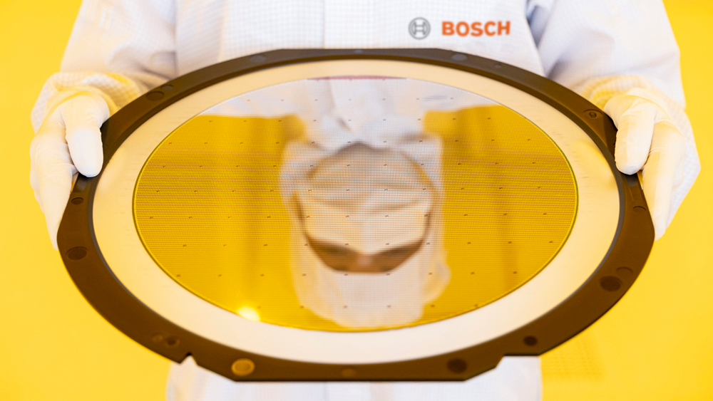 Person wearing a Bosch uniform holds a Semiconductor chip