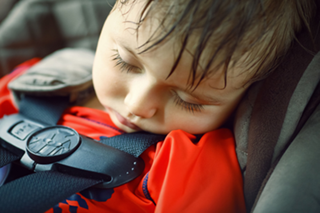 Baby sitting in car seat in hot car