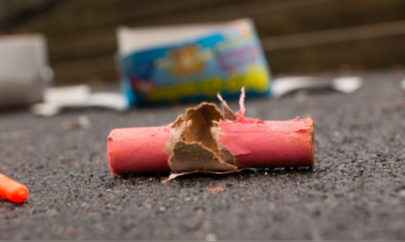 A used firework lays on the ground