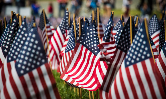 Mini American flags decorate a memorial lawn