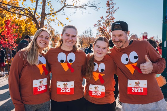 A family of four smiles while wearing Turkey sweaters