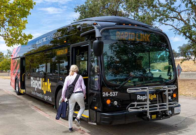 A woman steps onboard the RapidLink bus