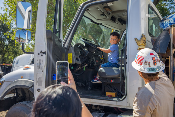 A young boy sits in the driver seat of a Roseville Electric truck