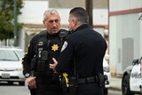 Salinas Police Chief Filice receiving an update from Commander Bravo