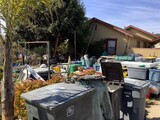 house with trash and blight in the yard