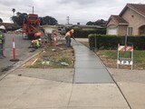 freshly poured concrete being smoothed out on Meadow Drive for sidewalk repair