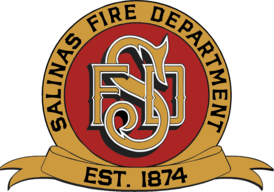red circle with gold ribbon that says Salinas Fire Department Est. 1874