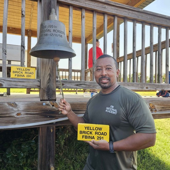 Commander Warner ringing the bell at the FBI academy