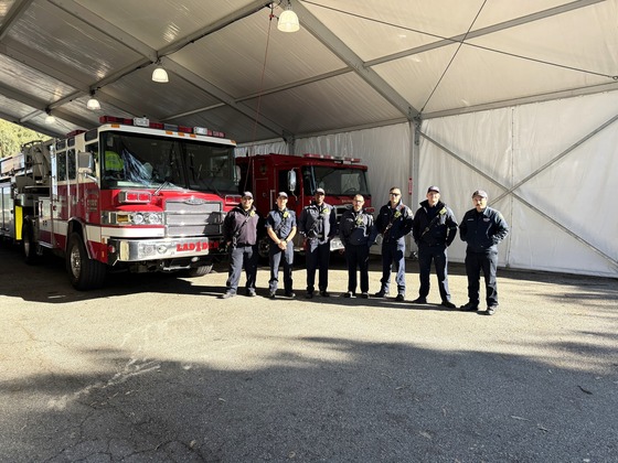 fire-personnel-standing-in-front-of-two-fire-trucks