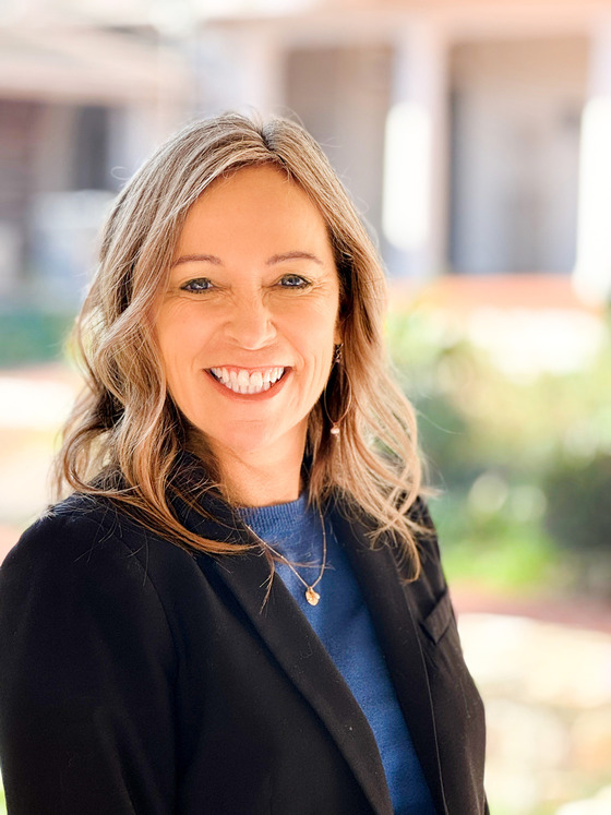 headshot photo of Lisa Murphy with blonde hair, blue eyes, black suit jacket and blue shirt