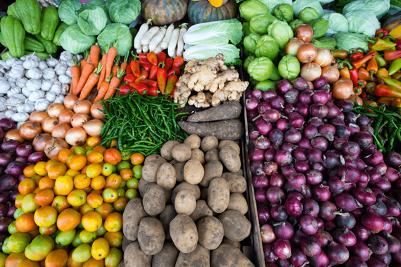 A wide look at fruits and vegetables on a table.