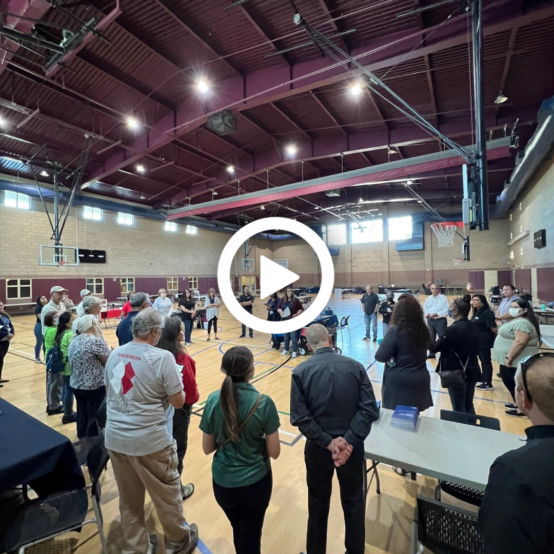 A photo of the people standing in a gymnasium at the Local Assistance Center in Yucaipa.