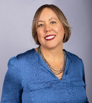 A photo of the human resources director, Diane Rundles dressed in a blue top smiling.