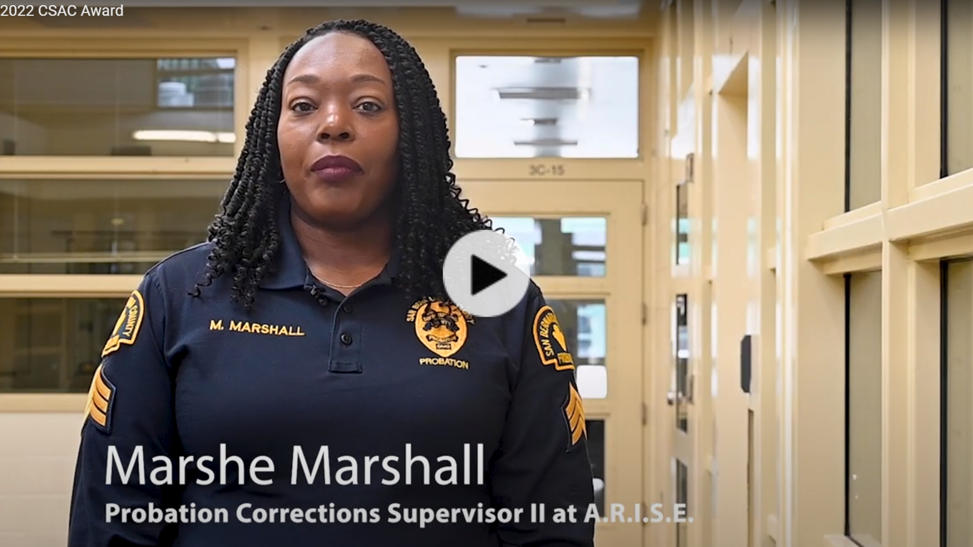 An African American female probation officer is pictured with the name Marshe Marshall with a video play button.