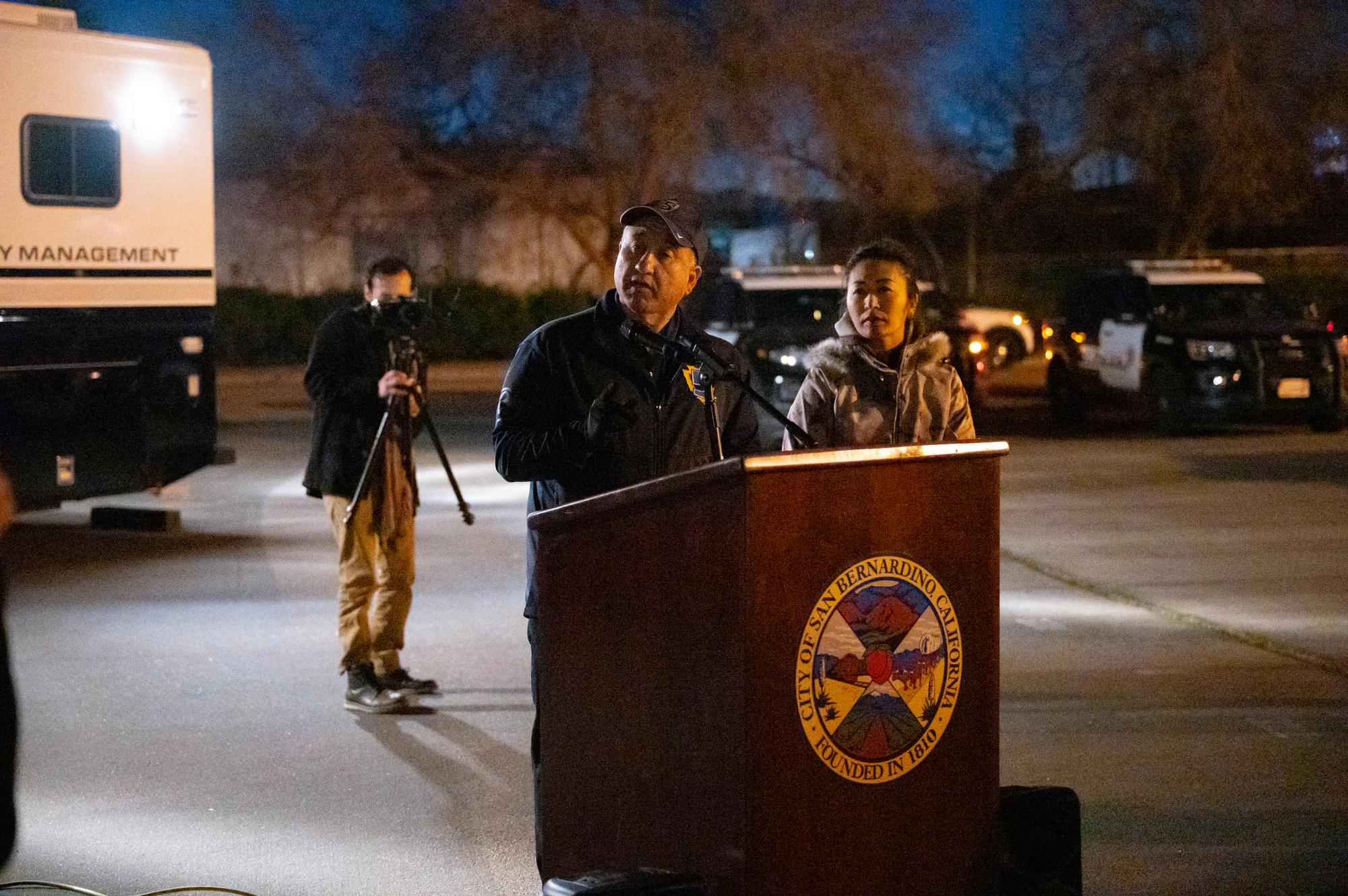 Supervisor Joe Baca. Jr., is seen at a podium talking to volunteers at sunrise.