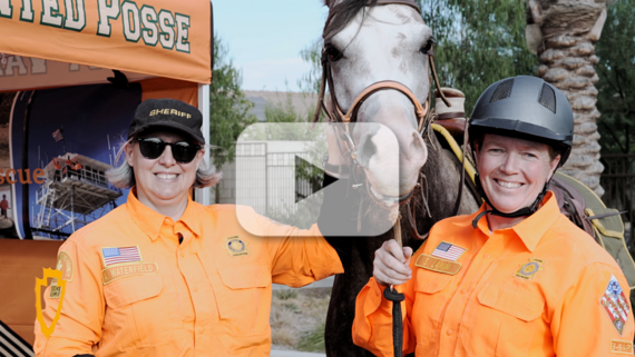 Two female San Bernardino County Sheriff Officers pose with a horse from the Horse & Rescue Team.