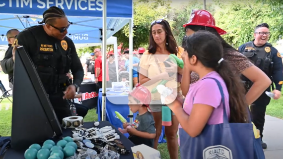 A San Bernardino County Probation officer connects with eventgoers at the National Night Out event at Ayala Community Park.