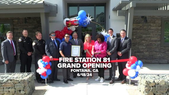 A group of San Bernardino County elected and appointed officials cutting a ribbon in front of the new Fontana Station 81 fire station.