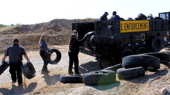 People loading trash into a truck